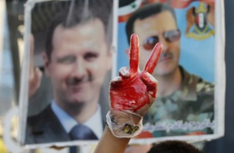 Assad protestors (photo credit: Reuters)