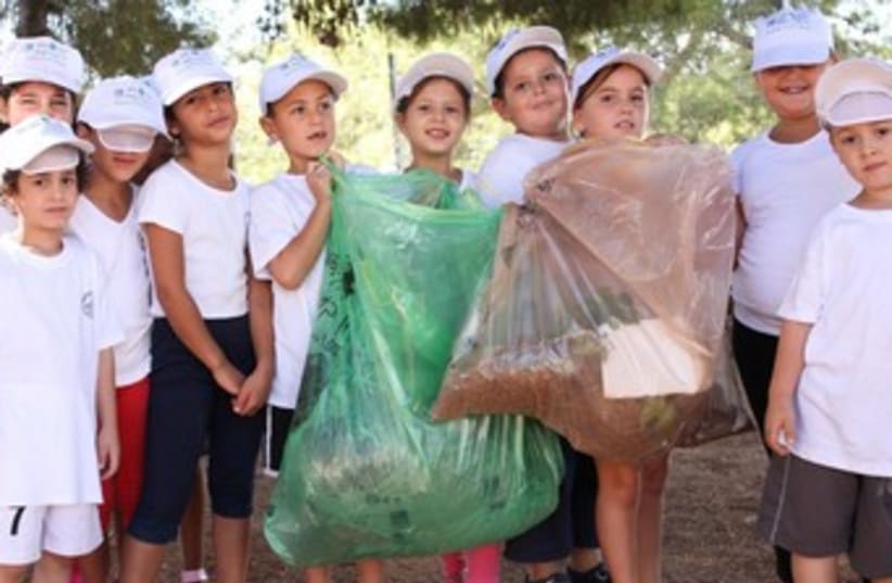 Children clean for World Clean-up Day (photo credit: Dror Artzy)