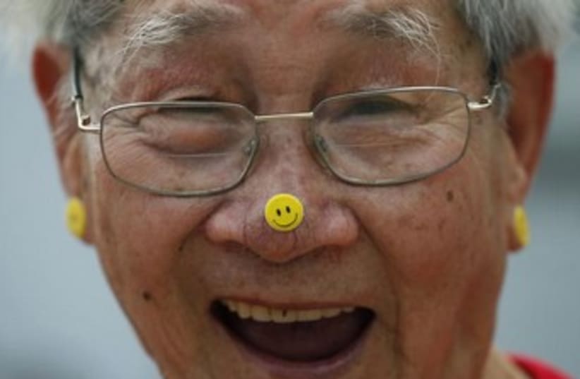 A man practices Laughter Yoga during the World Laughter Day (photo credit: Reuters)