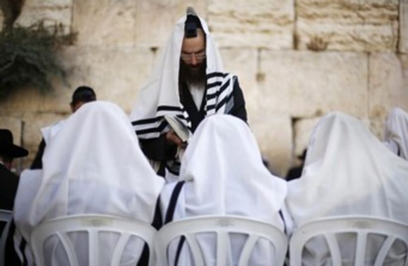 Jewish worshippers covered in prayer shawls pray @kotel 370 (photo credit: Courtesy Yazel Shavit Communications)