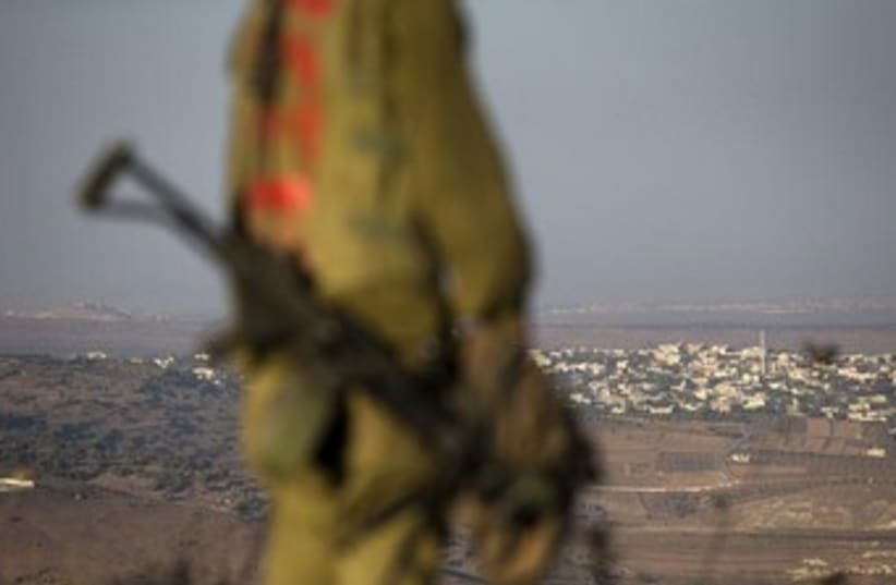 An Israeli soldier on the Golan Heights near Syria border370 (photo credit: Reuters)