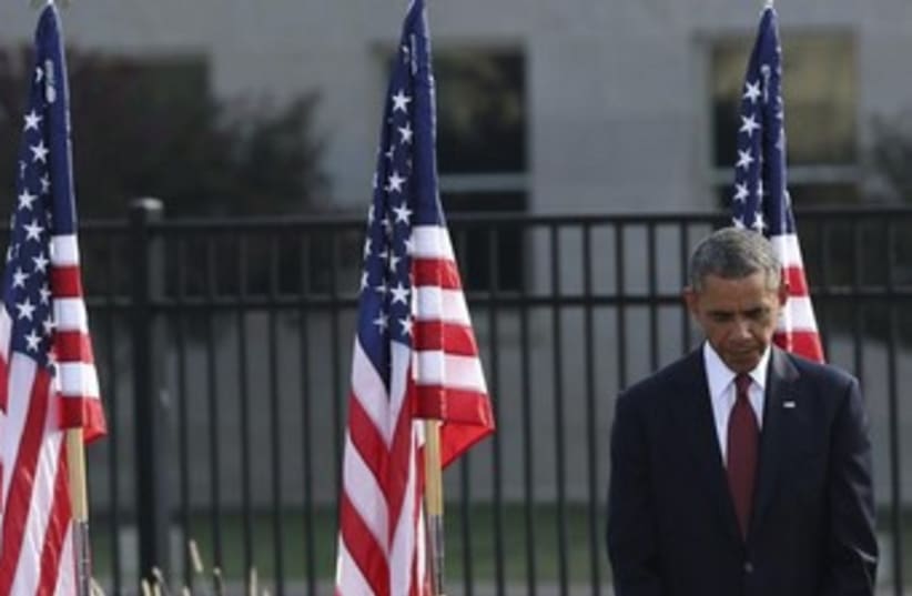 U.S. President Barack Obama bows his head (photo credit: Reuters)