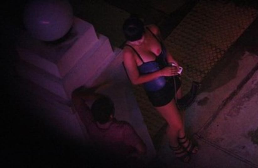woman prostitute talks to man 370 (photo credit: REUTERS)