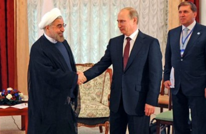 Putin and Rouhani shake hands 370 (photo credit: REUTERS)