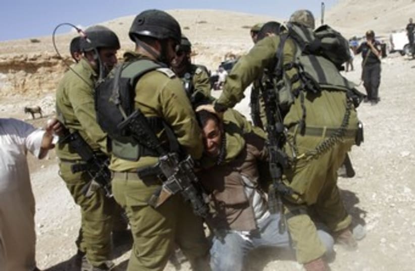 IDF soldiers detain Palestinian in Jordan Valley 370 (photo credit: REUTERS)