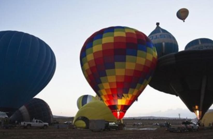 Hot air balloons are prepared during 2-day festival  (photo credit: REUTERS/Nir Elias)