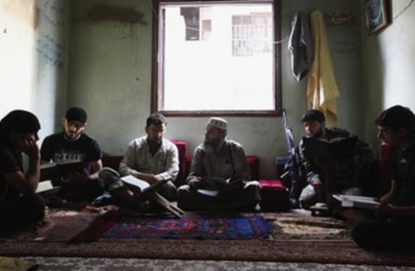 syrian rebels studying islam 370 (photo credit: REUTERS)