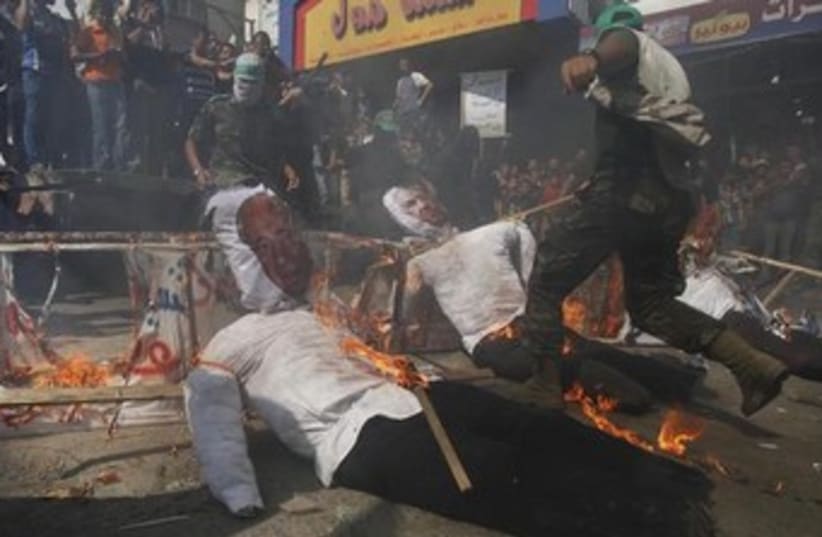 Burning Netanyahu, Peres dolls in Gaza 370 (photo credit: REUTERS/Ibraheem Abu Mustafa)