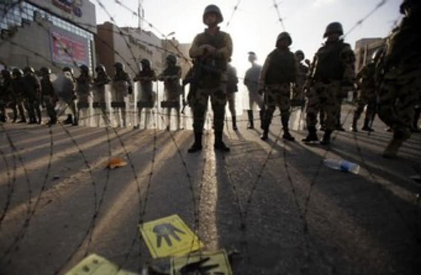 Egyptian soldiers stand guard near Rabaa al-Adawiya 370 (photo credit: REUTERS)