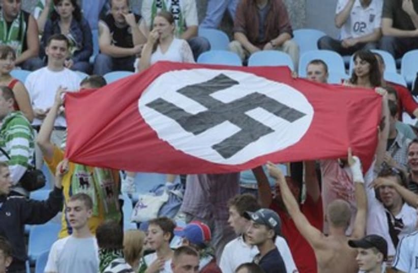 Soccer fans hold up Nazi swastika flag 370 (photo credit: REUTERS)