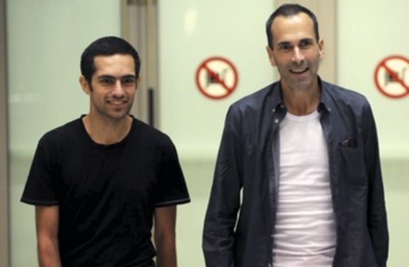 John Greyson (R) and Tarek Loubani arrive in Toronto (photo credit: Reuters)