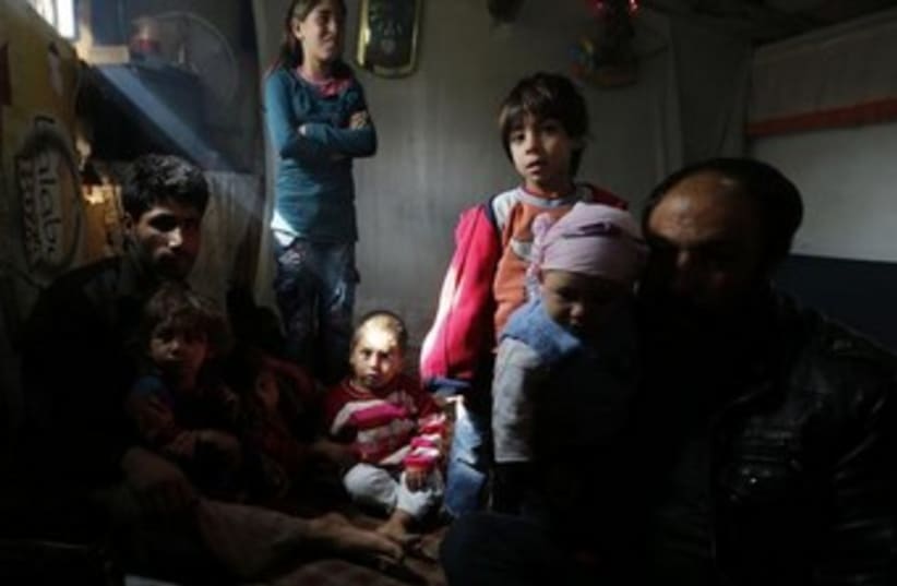 Syrian refugees spend time in their makeshift tents (photo credit: Reuters)