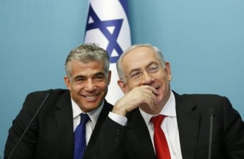 Netanyahu and Lapid laughing 370 (photo credit: REUTERS/Ronen Zvulun )