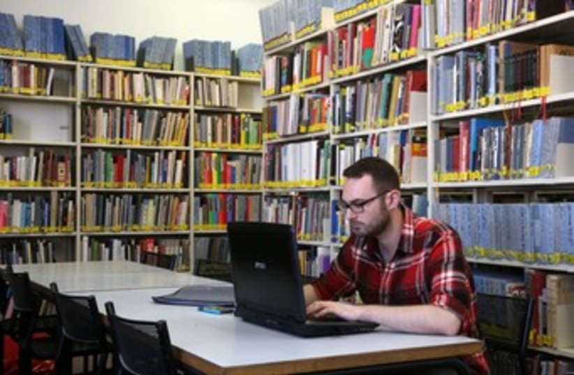 Student with laptop at Bezalel library 370 (photo credit: Marc Israel Sellem/The Jerusalem Post)