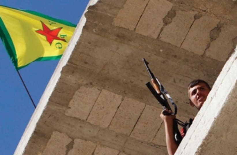 A Kurdish fighter from the YPG in Aleppo, Syria (photo credit: MUZAFFAR SALMAN / REUTERS)
