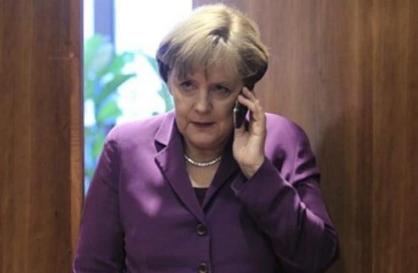Angela Merkel on the phone 370 (photo credit: REUTERS/Yves Herman)