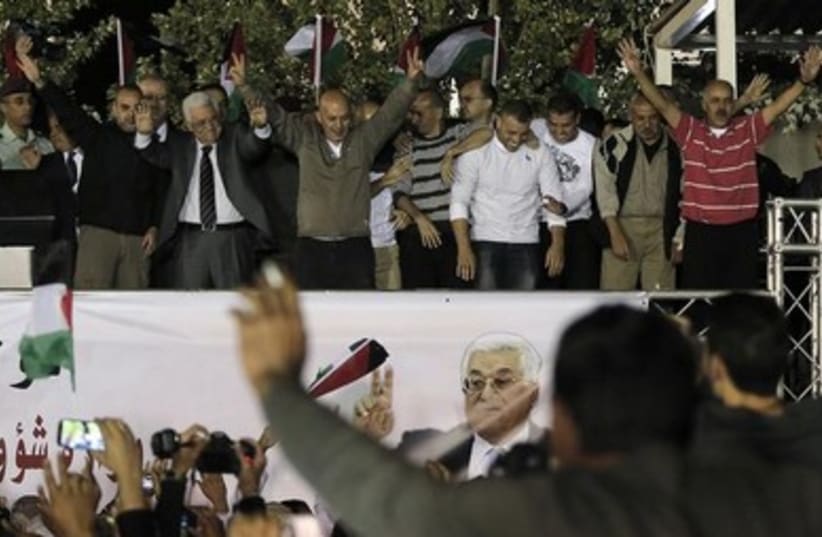 Abbas with released prisoners in Ramallah 390 (photo credit: REUTERS/Ammar Awad )