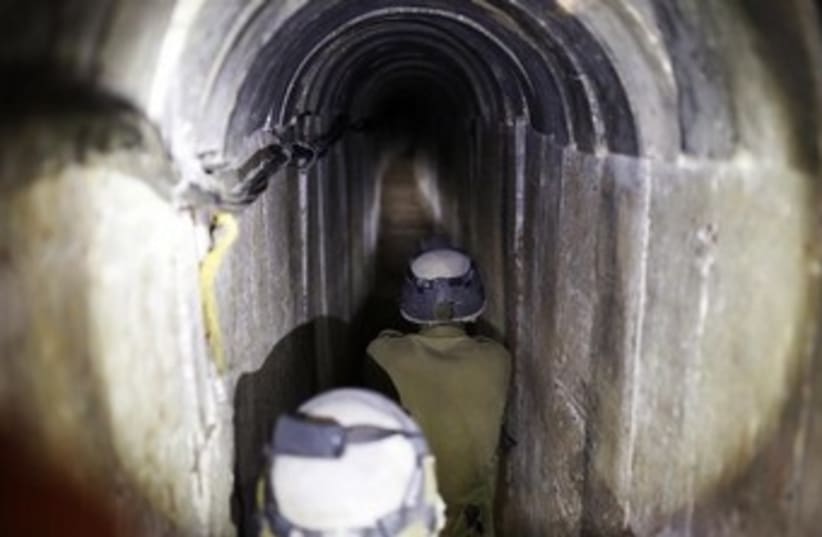 IDF soldiers walk down Hamas terror tunnel 370 (photo credit: REUTERS/Amir Cohen)