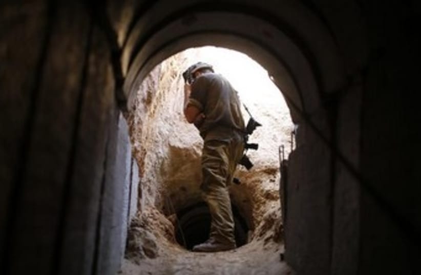 IDF soldier at Gaza tunnel 370 (photo credit: REUTERS/Amir Cohen)