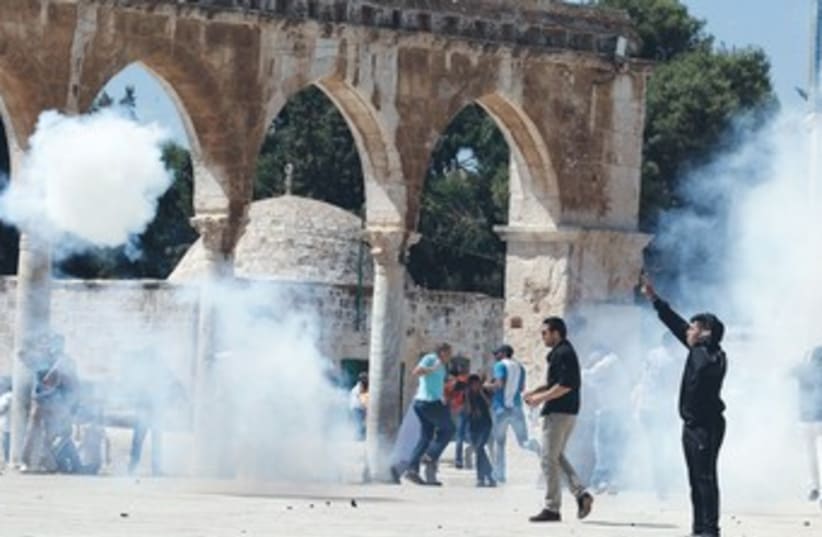 Palestinian protesters on Temple Mount 370 (photo credit: Ammar Awad/Reuters)