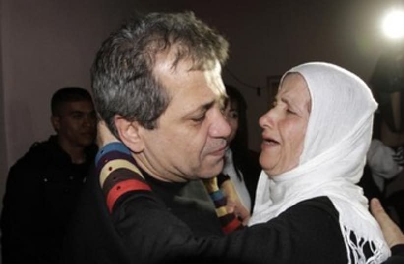 Moayyad Hajji hugs his sister after his release from prison  (photo credit: REUTERS)