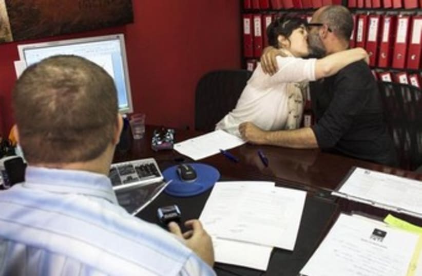 An Israeli couple signs an unofficial marriage agreement 370 (photo credit: REUTERS)