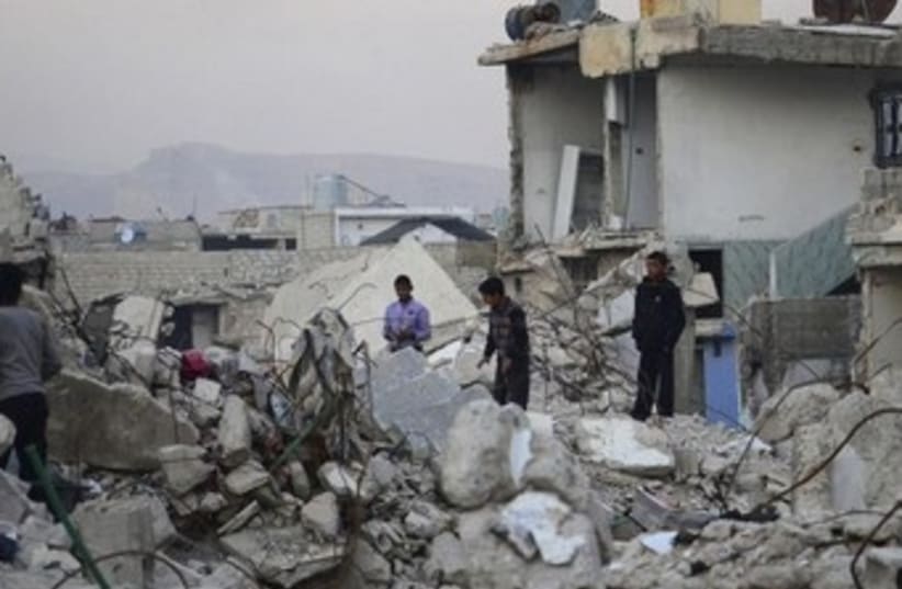 Syrian children survey damage in Damascus 370 (photo credit: REUTERS)