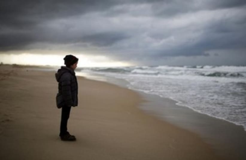 An Israeli girl stands on Zikim beach 370 (photo credit: REUTERS)