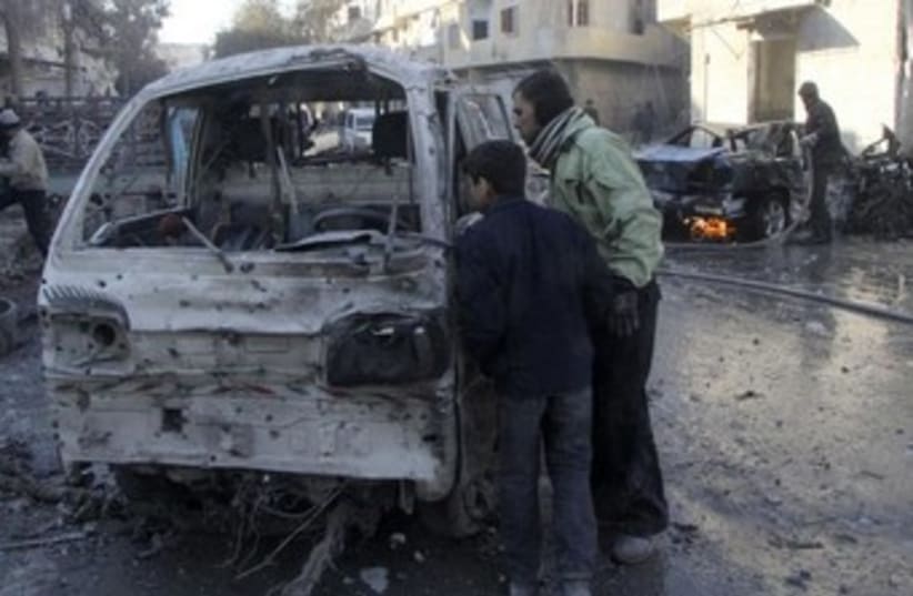 Syrians inspect damaged vehicle after Aleppo airstrike 370 (photo credit: Reuters)