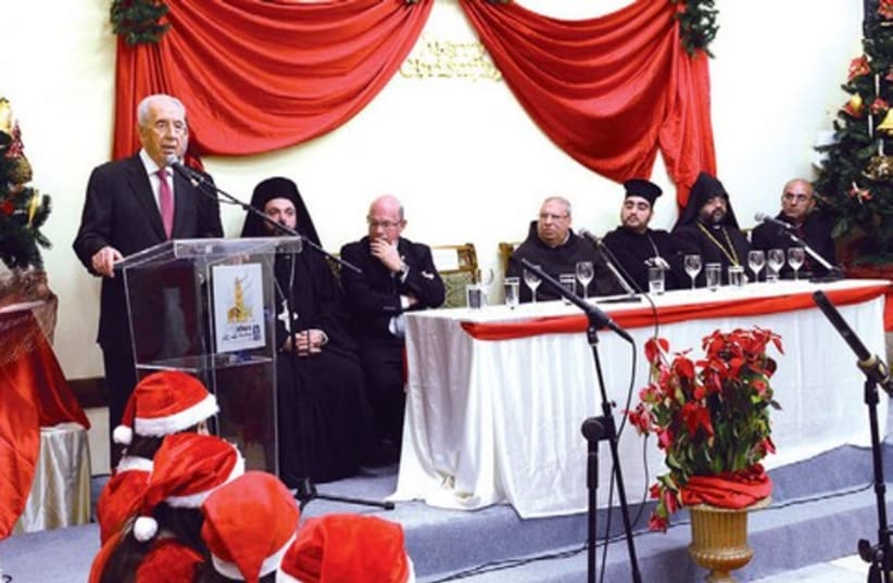 Peres at Christmas ceremony. (photo credit: GPO)