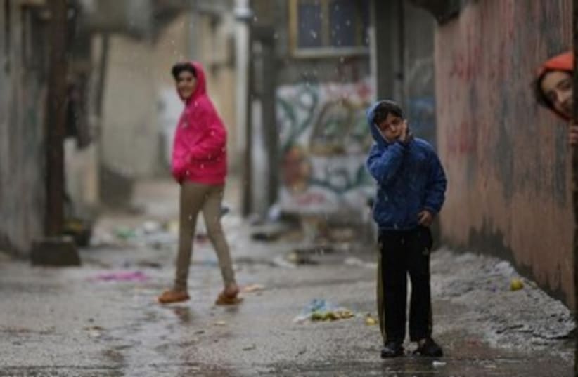 Palestinian children play in rain. [File] (photo credit: Reuters)