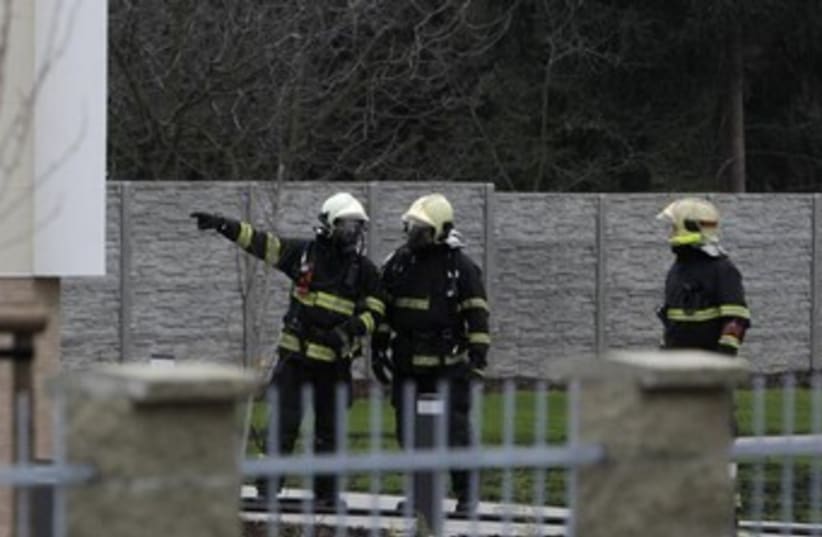 Firefighters search area after explosion. (photo credit: Reuters)
