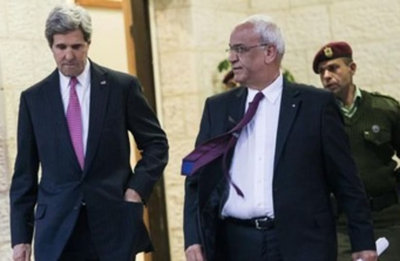 US Secretary of State John Kerry and chief PLO negotiator Saeb Erekat speaking to reporters in Ramallah, January 4, 2013. (photo credit: REUTERS/Brendan Smialowski/Pool)