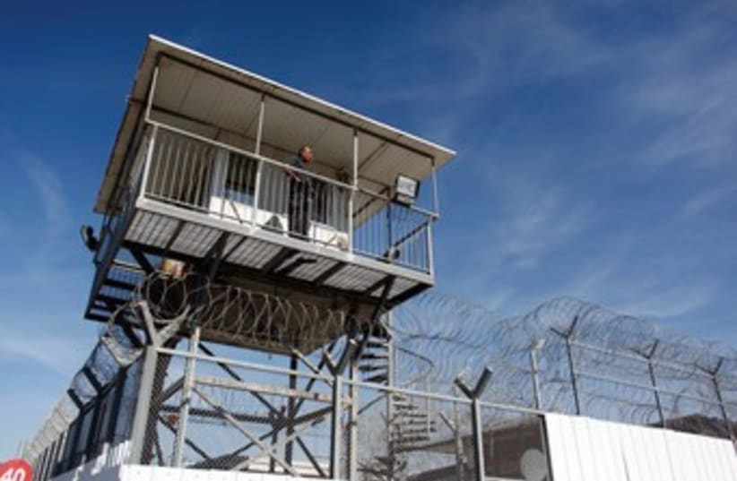 A guard keeps watch from a tower at Ayalon Prison in Ramle. (photo credit: REUTERS)