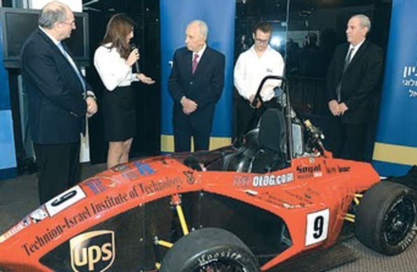 President Shimon Peres examines the race car built by Technion-Israel Institute of Technology students, January 8, 2014. (photo credit: Mark Neiman/GPO)