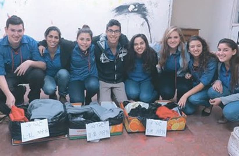 Israeli teenagers gather clothes for victims of the Syrian civil war. (photo credit: Operation Human Warmth)