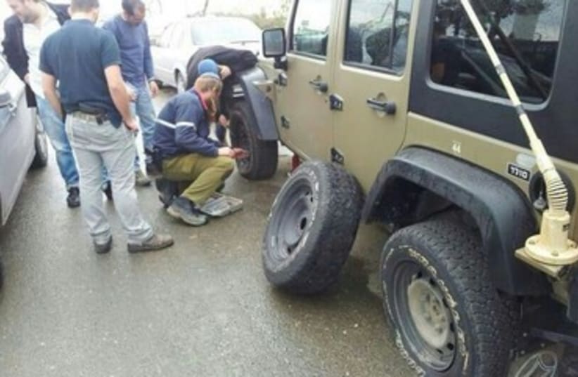 Army vehicle with punctured tires, West Bank, January 10, 2014 (photo credit: IDF Spokesperson, Courtesy)