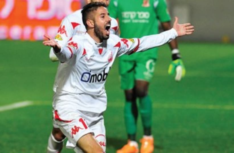 Hapoel Beersheba striker Dovev Gabai celebrates after scoring his team’s winner in the 94th minute of Saturday’s 2-1 victory over Bnei Yehuda at Bloomfield Stadium. (photo credit: Asaf Kliger)