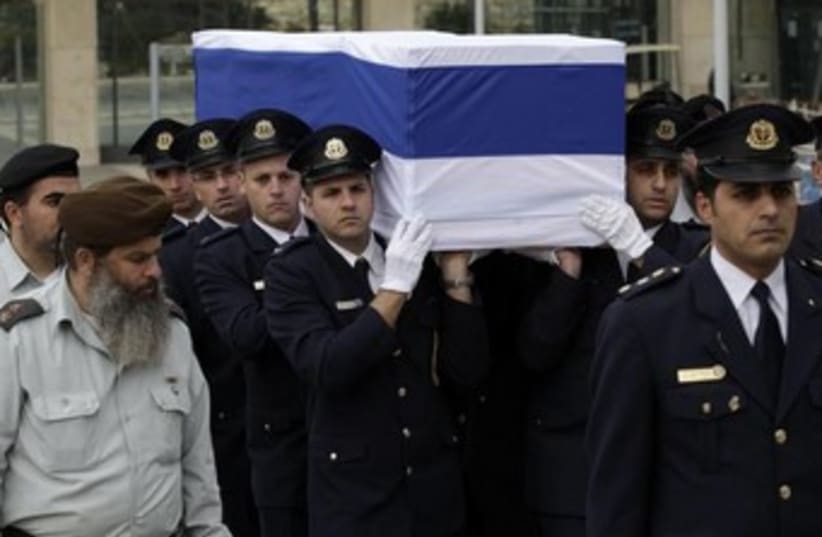Knesset guard carry former PM Ariel Sharon's coffin, January 12, 2014. (photo credit: REUTERS/Ronen Zvulun)