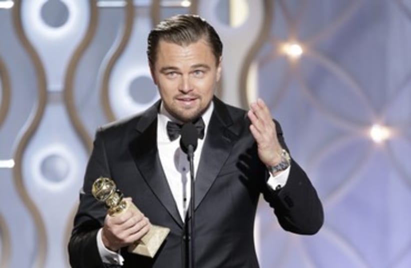 Leonardo DiCaprio accepts his Golden Globe. (photo credit: reuters)