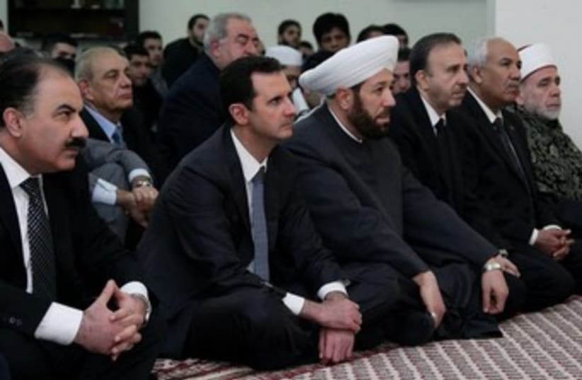 Syrian President Bashar Assad attends prayers marking the birth of the Prophet Muhammed (photo credit: Reuters)