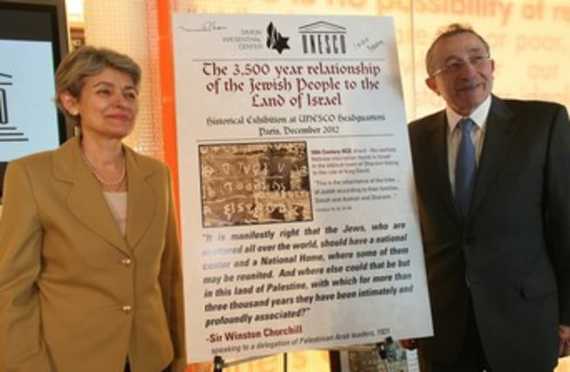 UNESCO director-general Irina Bokova with Simon Wiesenthal Center Dean Rabbi Marvin Hier, next to a panel announcing the exhibit in 2012. (photo credit: Courtesy)