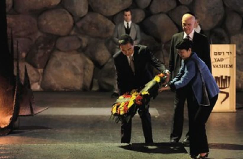 CHINESE FOREIGN Minister Wang Yi lays a wreath during a ceremony in the Hall of Remembrance at the Yad Vashem Holocaust memorial in December. (photo credit: REUTERS)