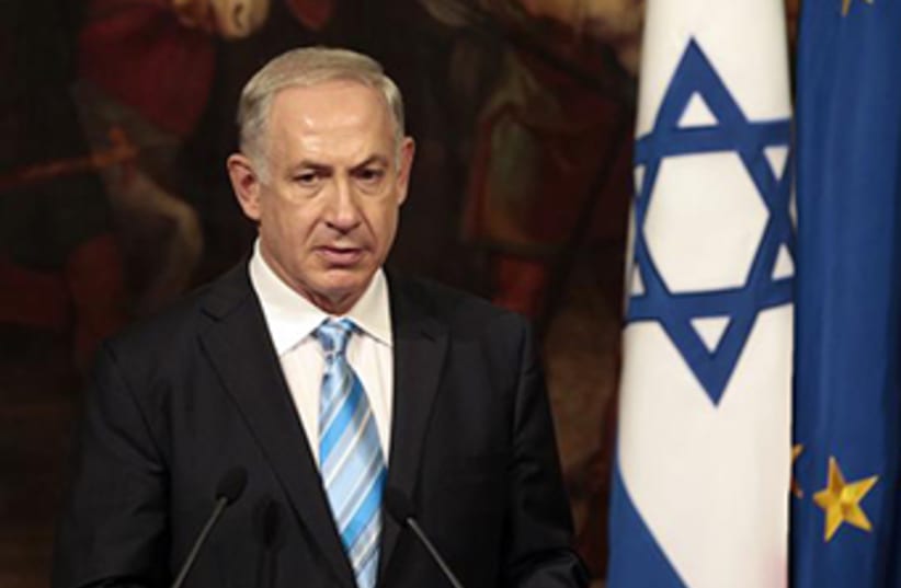 Prime Minister Binyamin Netanyahu backed by Israeli and EU flags (photo credit: REUTERS)