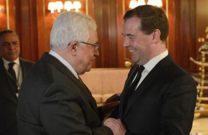 Russia's Prime Minister Dmitry Medvedev (R) meets with Palestinian President Mahmoud Abbas at the Gorki residence outside Moscow January 23, 2014.  (photo credit: REUTERS)