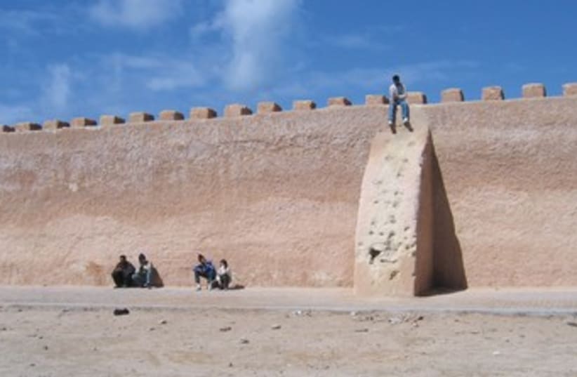 A YOUTH sits on the walls of Essaouira. (photo credit: BEN G. FRANK)