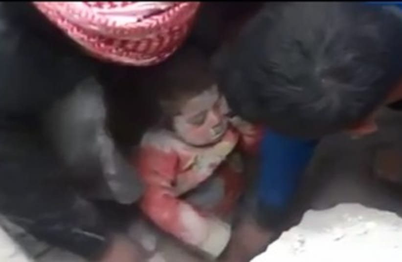 Toddler rescued from rubble in Aleppo, Syria (photo credit: REUTERS)