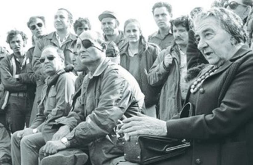 Then-prime minister Golda Meir with IDF soldiers and defense officials after the end of the Yom Kippur War in 1973. (photo credit: REUTERS)