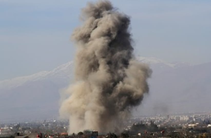Smoke after alleged Barrel-bomb explosion in Syria, January 31, 2014 (photo credit: REUTERS)