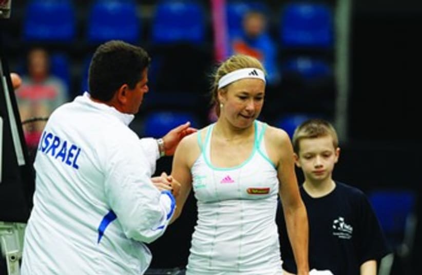 Israel Fed Cup captain Amos Mansdorf (left) consoles Julia Glushko after her defeat to Nadiya Kichenok during the team’s 3-0 loss to Ukraine yesterday in Europe/Africa Zone Group I action from Budapest, Hungary. (photo credit: NIR KEIDAR/ISRAEL TENNIS ASSOCIATION)